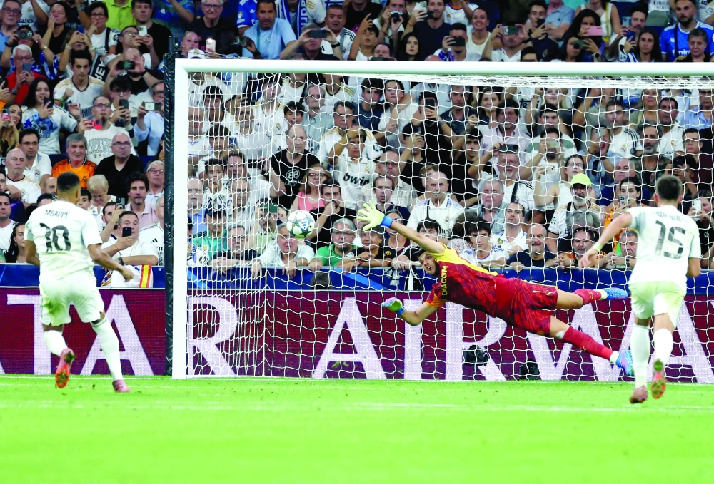 Real Madrid's French forward #10 Kylian Mbappe scores his team's first goal from the penalty spot during the UEFA Champions League first round day 1 football match between Real Madrid CF and Olympique de Marseille. — AFP 