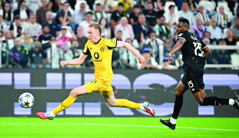 Borussia Dortmund's Maximilian Beier in action with Juventus' Pierre Kalulu. — Reuters