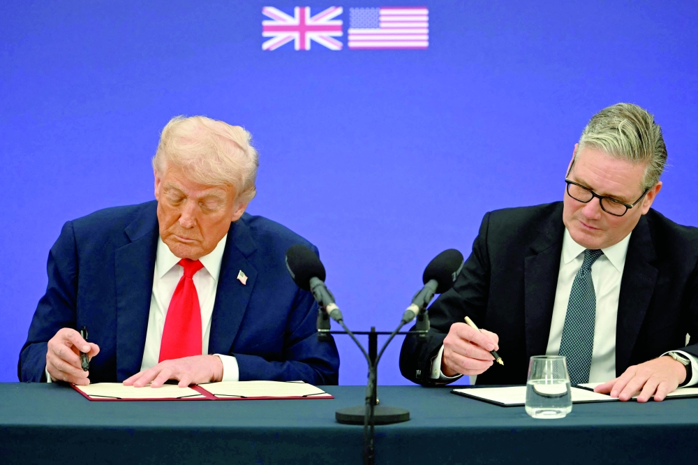 Britain's Prime Minister Keir Starmer and US President Donald Trump sign a technology property deal in Aylesbury, central England, on the second day of the US President's State Visit. - AFP 