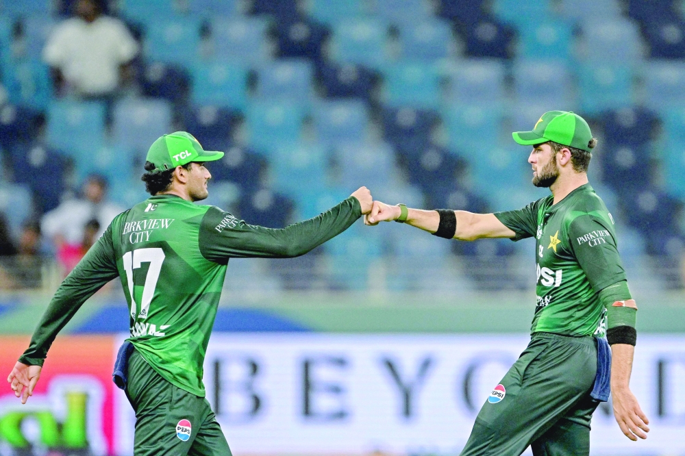 
Pakistan’s Shaheen Shah Afridi (R) and Hasan Nawaz bump their fists to celebrate the dismissal of UAE’s Asif Khan. — AFP 