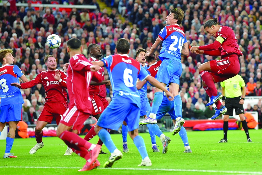 
Liverpool’s Virgil van Dijk scores their third goal against Atletico Madrid during the Champions League first round at Anfield . — Reuters 