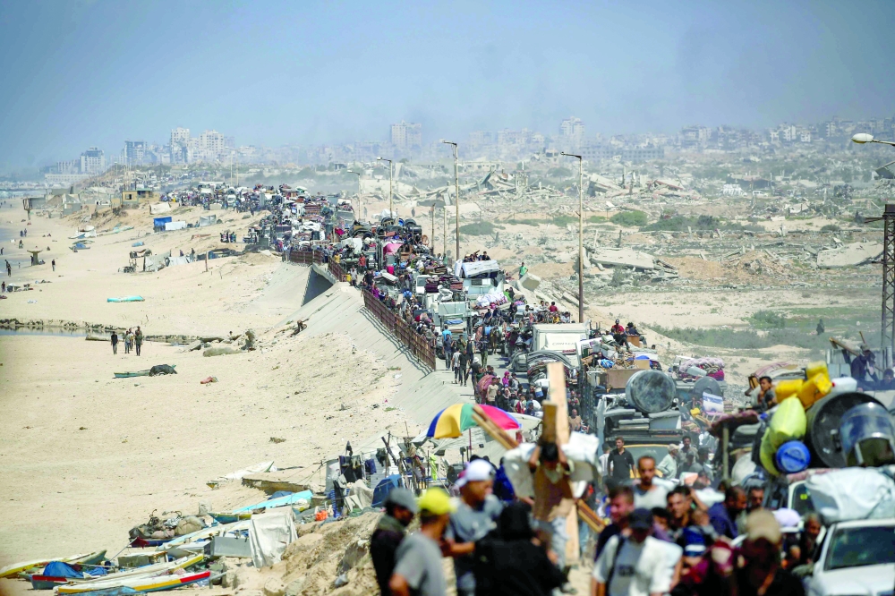 Palestinians from Gaza City move southwards with their belongings, near the Nuseirat refugee camp in the central Gaza Strip. — AFP