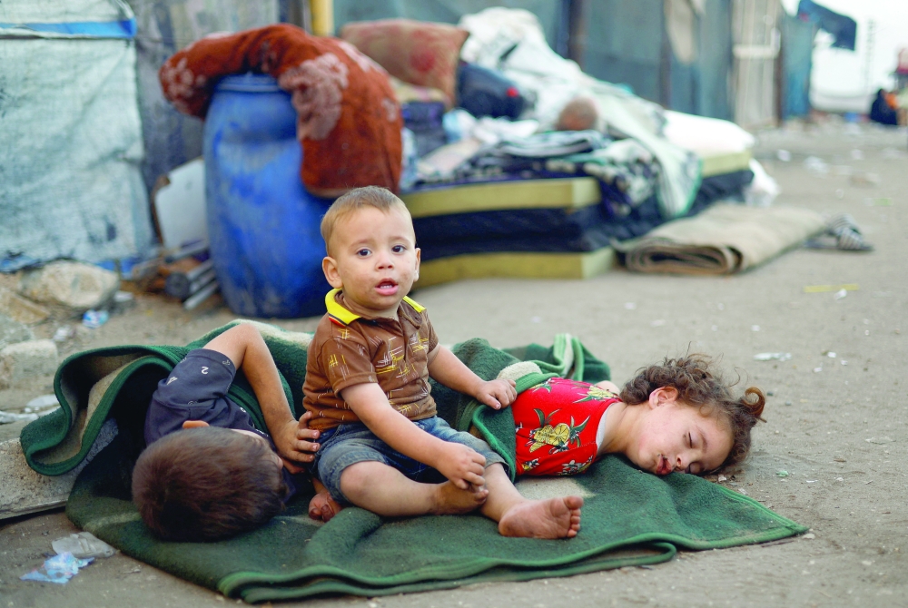 Palestinian children fleeing northern Gaza due to an Israeli military operation on Friday. — AFP