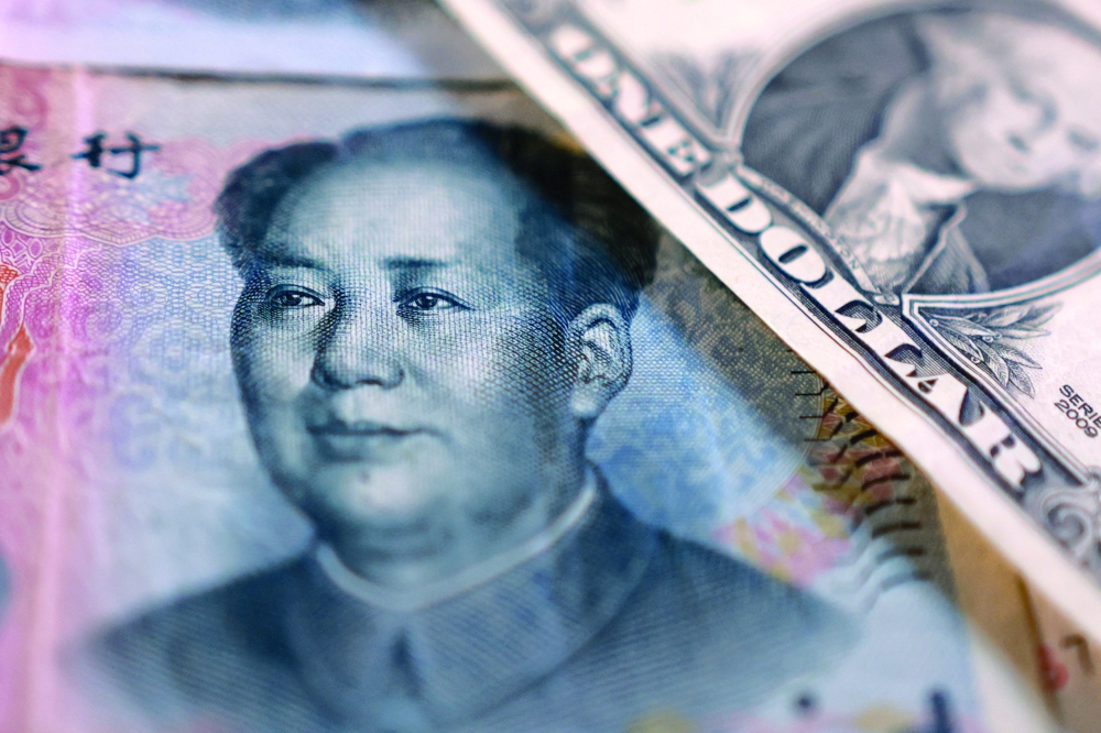 Illustration shows US dollar and Chinese Yuan banknotes
