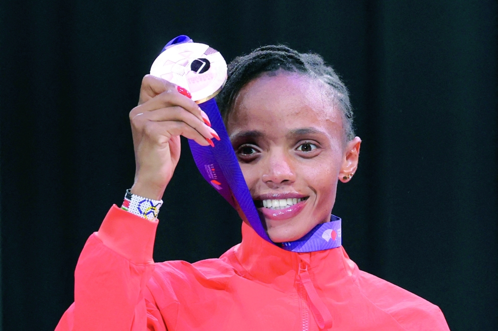 Gold medallist, Kenya's Beatrice Chebet celebrates on the podium. — Reuters