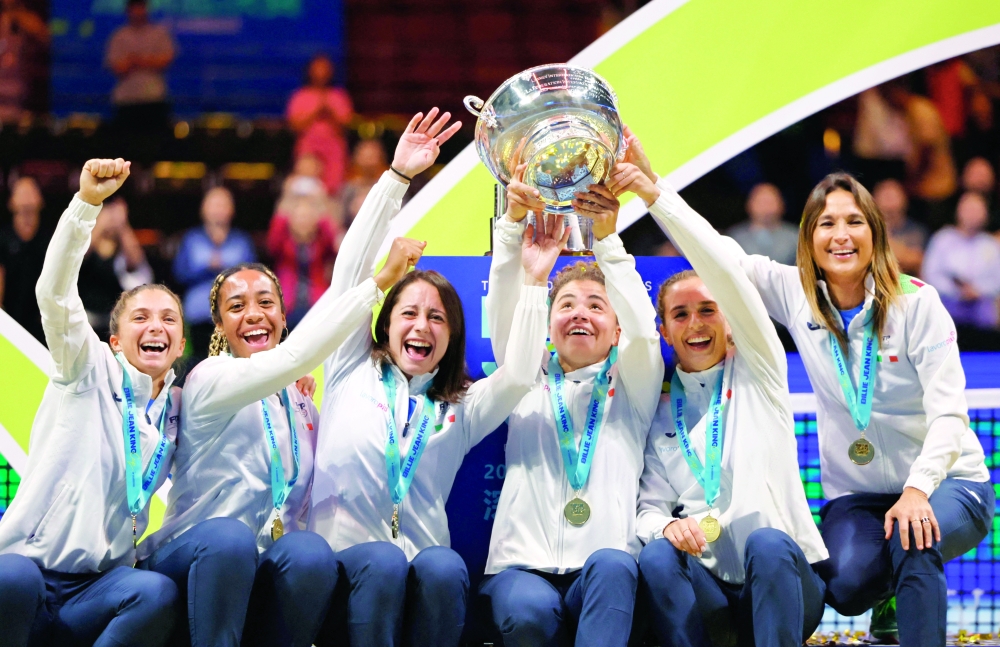 Italy's Jasmine Paolini, Lucia Bronzetti, Elisabetta Cocciaretto, Tyra Grant, Sara Errani and captain Tathiana Garbin celebrate with the trophy after winning the final. — Reuters