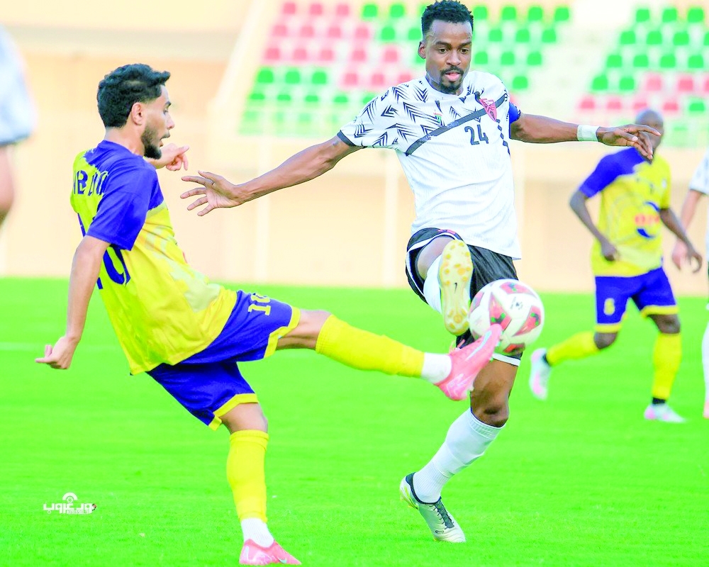 Al Rustaq and Ibri player fight for the ball