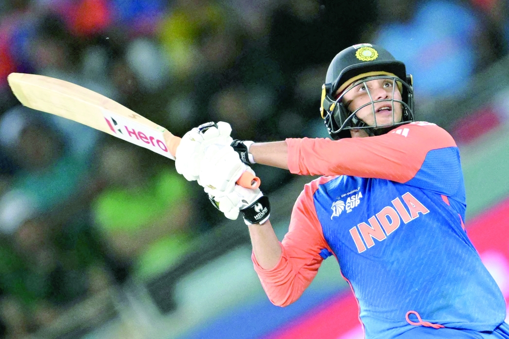 India's Abhishek Sharma watches the ball after playing a shot during the Asia Cup 2025 Super Four Twenty20 international cricket match between India and Pakistan at the Dubai International Stadium in Dubai on September 21, 2025.  (Photo by Sajjad HUSSAIN / AFP)
