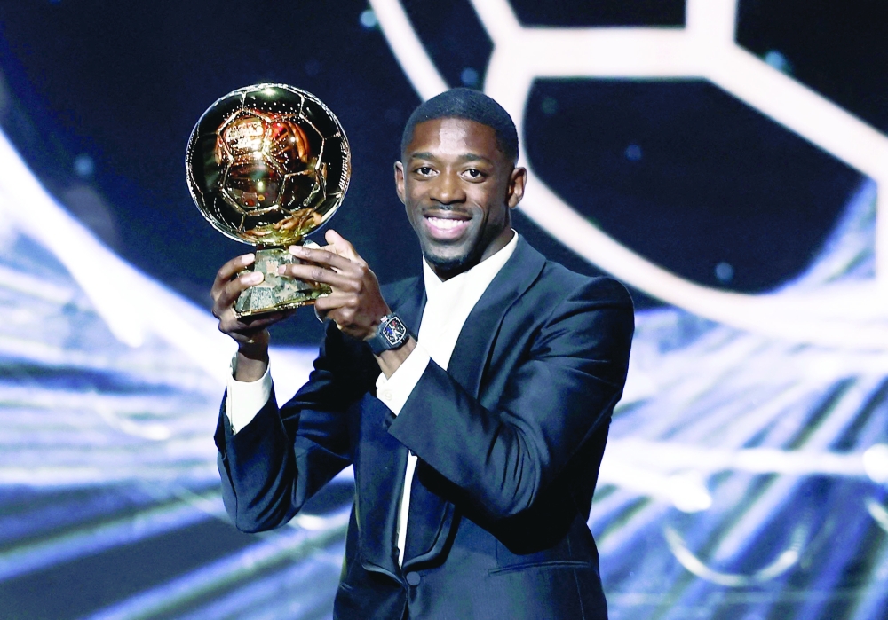 Paris St Germain's Ousmane Dembele celebrates after winning the men's Ballon d'Or award. — Reuters