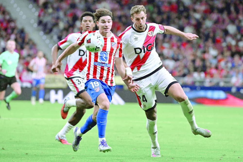 Atletico Madrid's Argentine forward #19 Julian Alvarez (L) vies for the ball with Rayo Vallecano's French defender #24 Florian Lejeune during the Spanish league football match between Club Atletico de Madrid and Rayo Vallecano de Madrid at the Metropolitano stadium in Madrid. — AFP