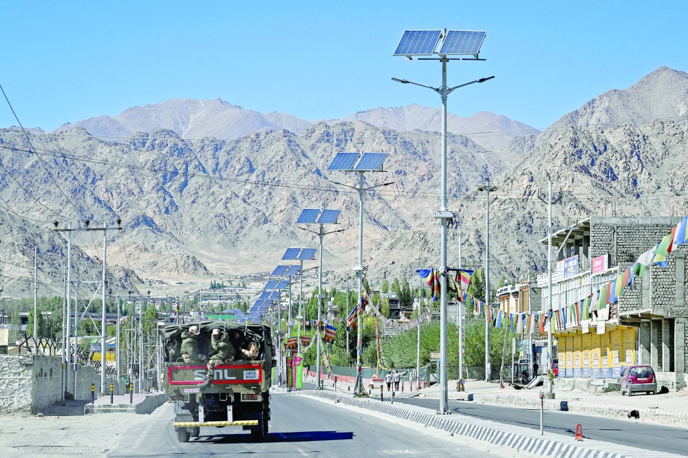 Indian security personnel in a truck patrol a deserted road during a curfew imposed by the administration in Leh, following violent clashes between police and demonstrators. - AFP