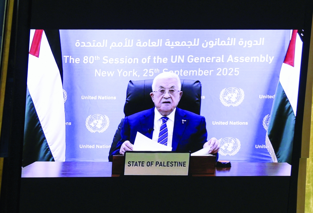 Palestinian President Mahmud Abbas appears on a screen as he addresses the 80th United Nations General Assembly, at the UN headquarters in New York.