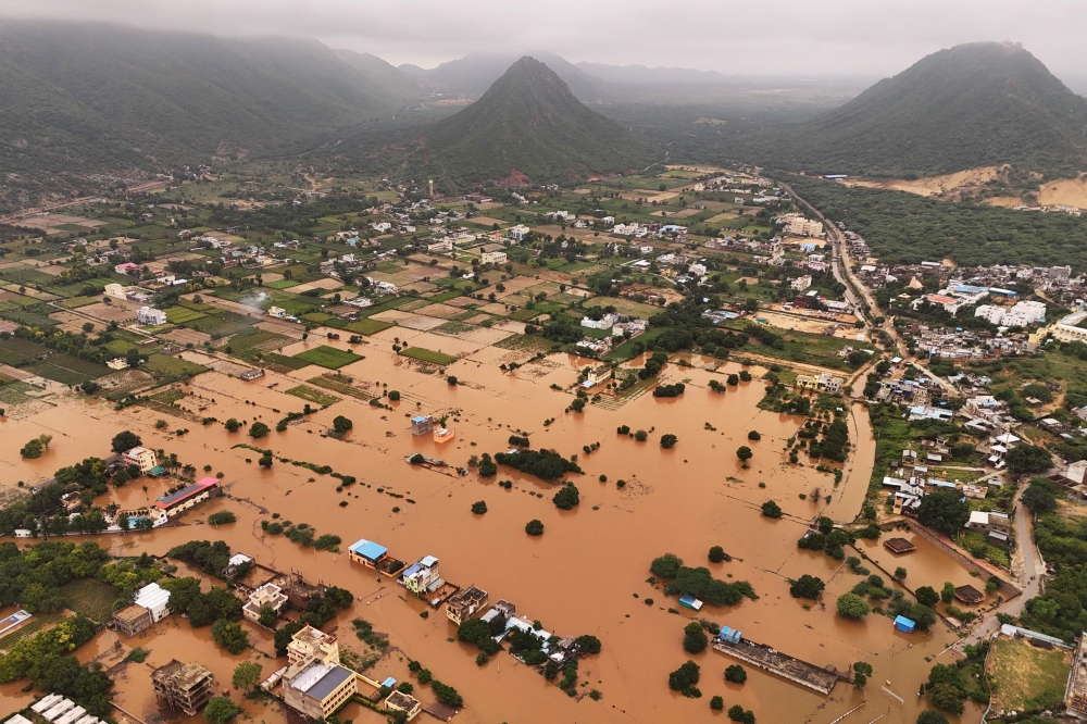 An aerial view shows buildings partially submerged in floodwaters after heavy monsoon rains in Pushkar on July 19, 2025.