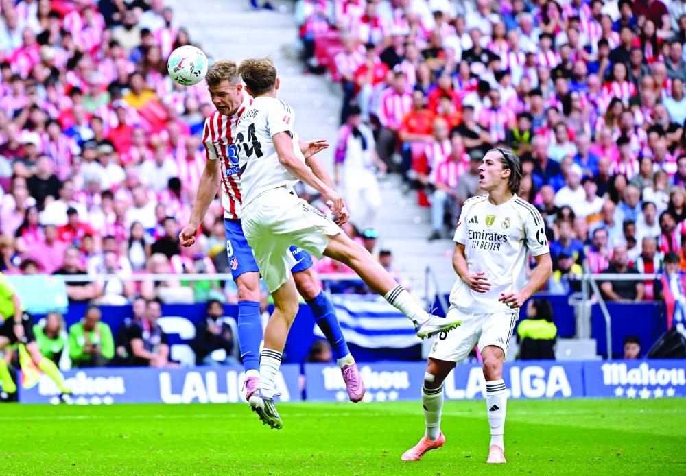 Atletico Madrid's Norwegian forward #09 Alexander Sorloth heads the ball and scores his team's second goal during the Spanish league football match between Club Atletico de Madrid and Real Madrid CF at the Metropolitano stadium in Madrid. — AFP 