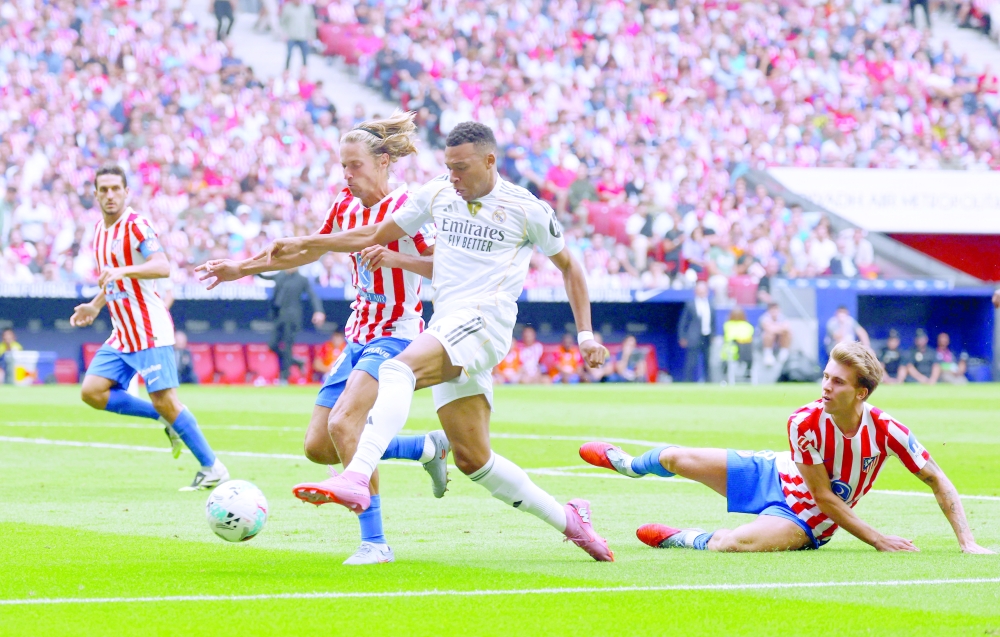 Real Madrid's Kylian Mbappe in action with Atletico Madrid's Marcos Llorente. — Reuters