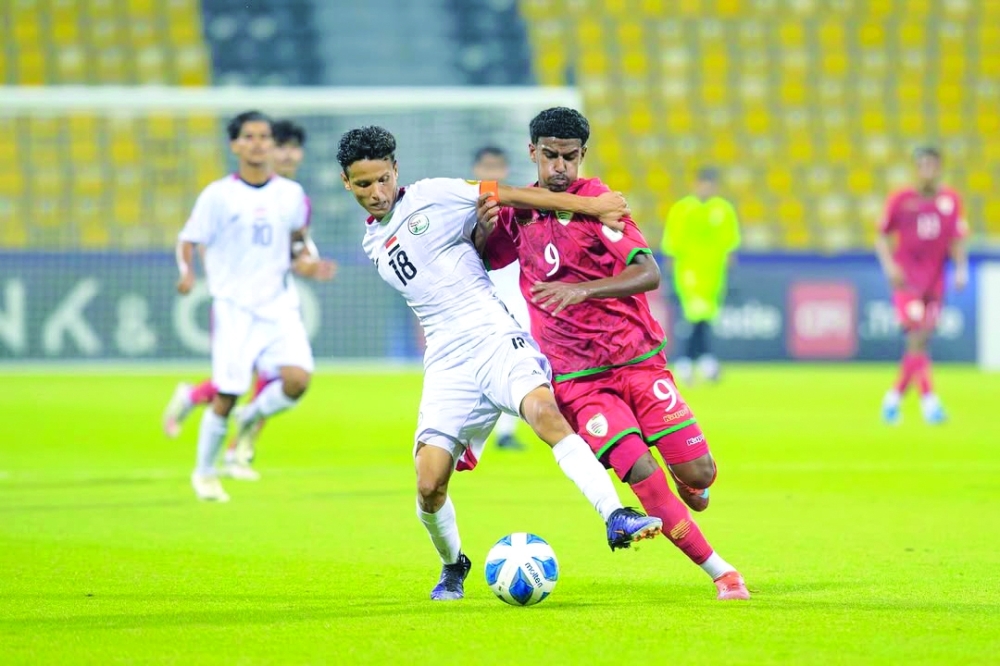   Oman and Yemen players fight for the ball