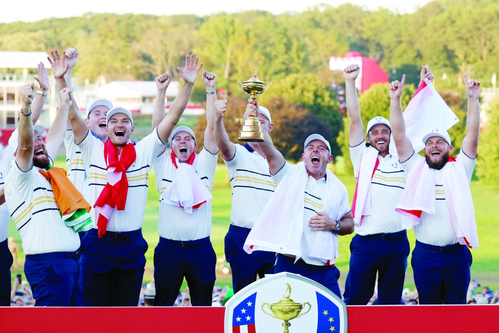 Team Europe's Rory McIlroy and teammates celebrates with the trophy after winning the Ryder Cup. — Reuters