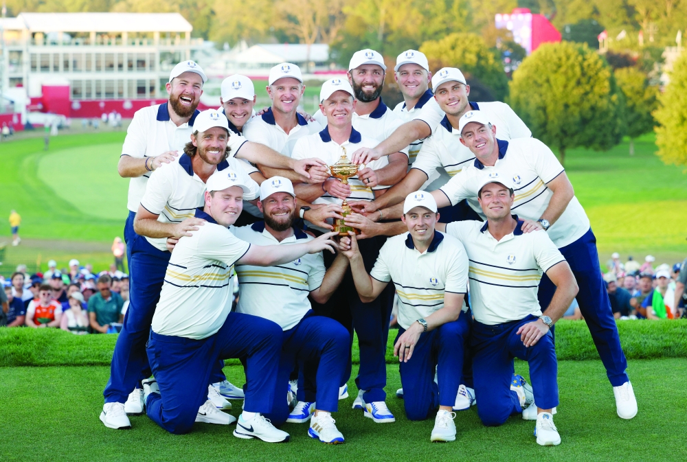 Team Europe captain Luke Donald and his team pose with the trophy as they celebrate after winning the Ryder Cup. — Reuters