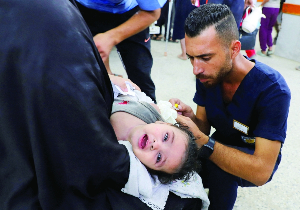 A wounded Palestinian child receives treatment at Al Shifa Hospital after being injured in an Israeli strike in Gaza City on Monday. — Reuters