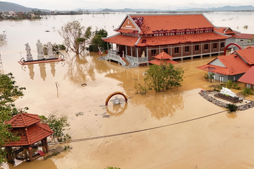 An aerial photo shows flood waters surrounding a pagoda complex after typhoon Bualoi passed over Lam Thanh