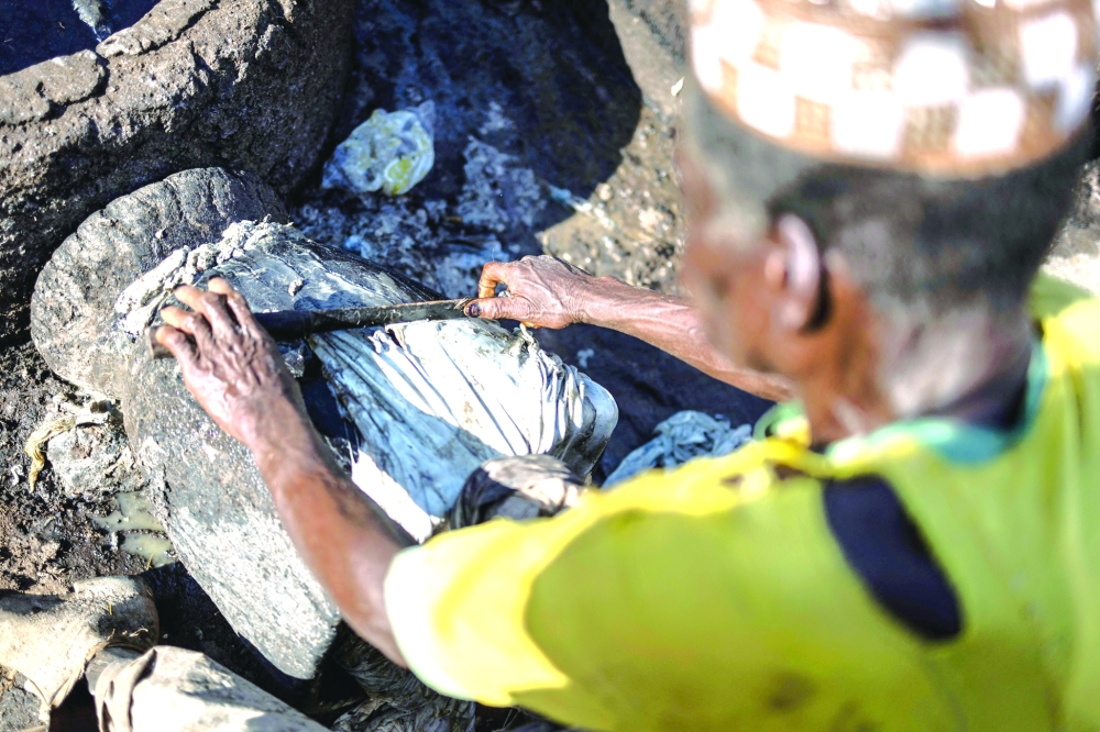 A tanner scrapes residue of meat from s soaked hide at the Majema traditional tannery in Kofar Wambai neighbourhood in Kano, on September 10, 2025. The historic leather hub, Kano, feeds luxury giants like Louis Vuitton, Gucci, and Ralph Lauren, with Nigeria exporting nearly 90% of its hides abroad. But because the finishing work is done in Europe, the “Made in Nigeria” label vanishes, replaced by “Made in Italy” or “Made in Spain.” Now, some Nigerian designers are trying to reclaim the country’s leather identity by building homegrown brands.
