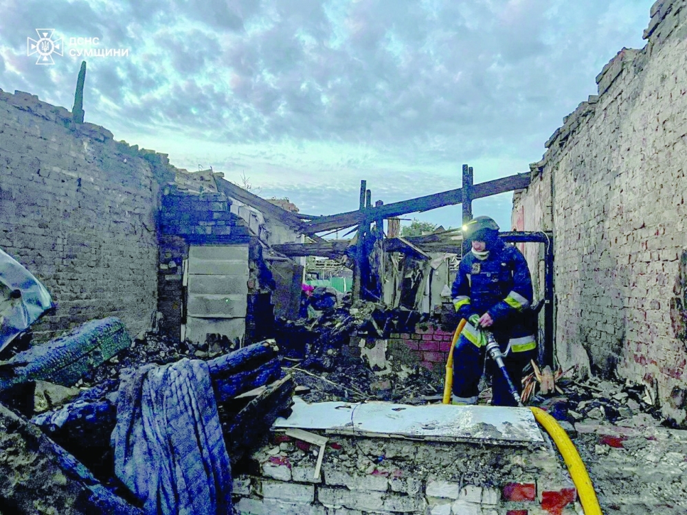 A firefighter works at the site of a Russian drone strike, in Sumy region. — Reuters