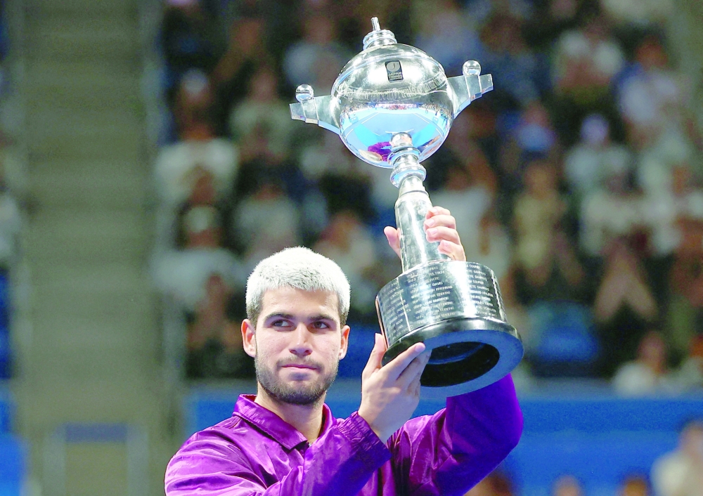 Spain's Carlos Alcaraz celebrates with the trophy after winning the final against Taylor Fritz of the US. — Reuters
