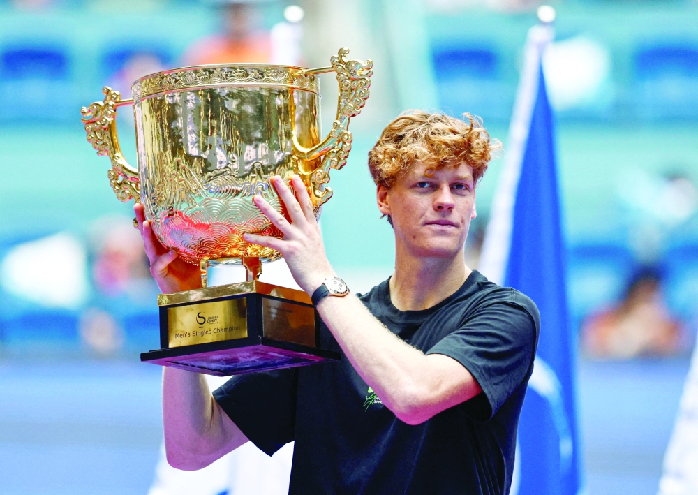 Italy's Jannik Sinner celebrates with the trophy after winning the final against Learner Tien of the US. — Reuters