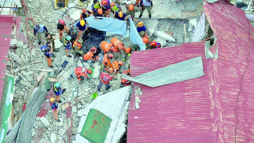 A drone view shows rescue workers conducting a rescue operation in Bogo, Cebu, Philippines. — Reuters
