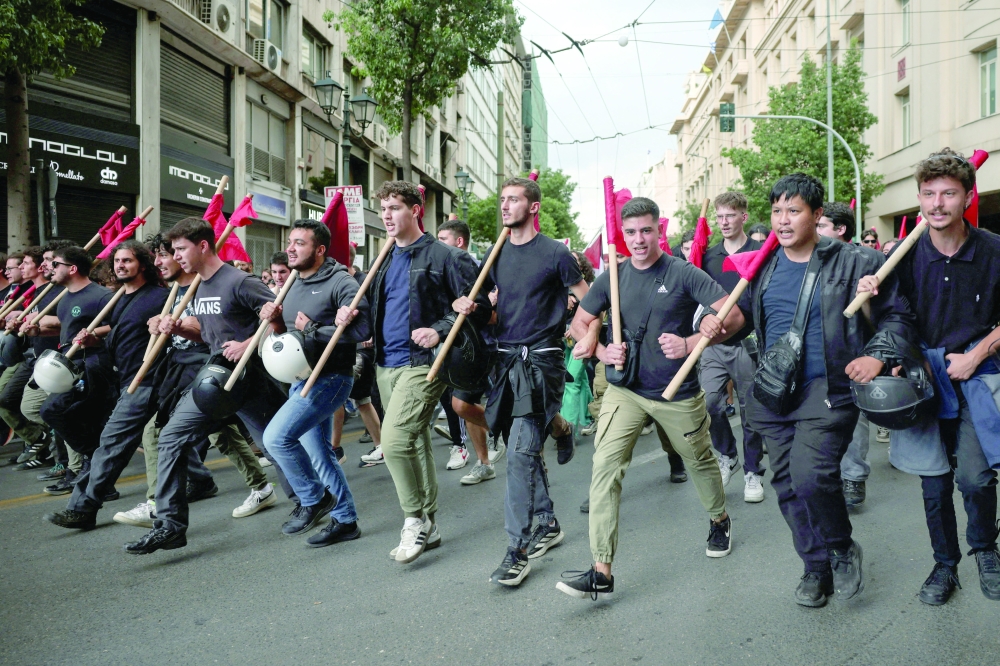 People march during a demonstration marking general strike, in Athens, Greece. — Reuters