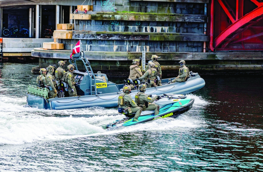 Danish police officers patrol on a boat in an area near the Christiansborg Palace, in Copenhagen. — AFP