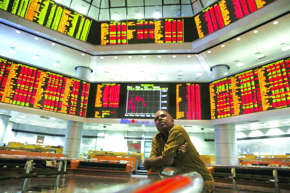 An investor monitors share market prices in Kuala Lumpur, Malaysia