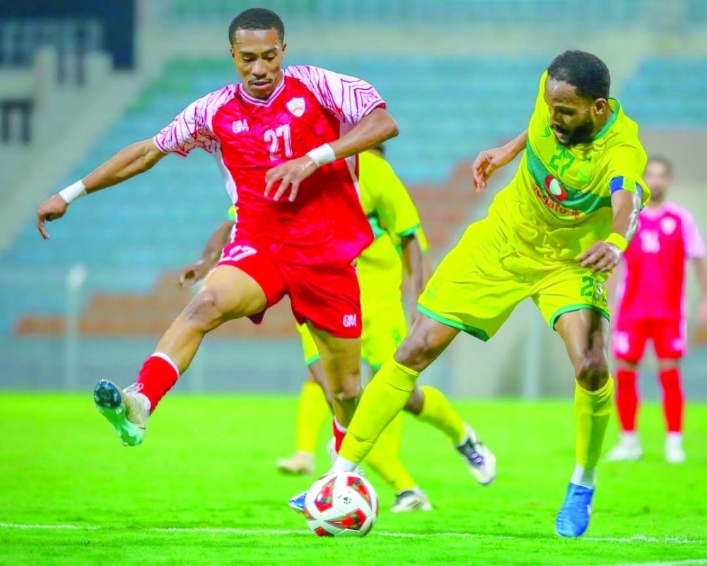Seeb and Oman Club players fight for the ball.