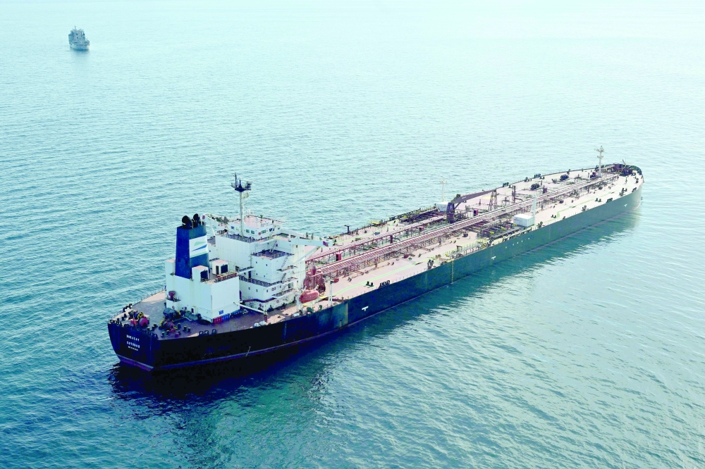 Tanker Boracay from Russia's so-called 'shadow fleet' suspected of being involved in drone flights over Denmark which sailed off the Danish coast in the background. - AFP