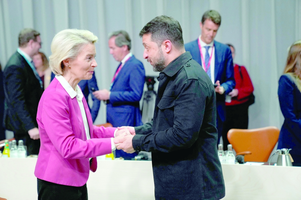 European Commission President Ursula Von der Leyen and Ukraine's President Volodymyr Zelensky arrive for a working session of the 7th European Political Community (EPC) Summit at the Bella Center in Copenhagen. - AFP