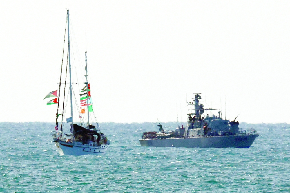 An Israeli navy vessel escorts a vessel from the Global Sumud Flotilla to Ashdod Port, after Israel intercepted some of the vessels of the Flotilla aiming to reach Gaza on Thursday. — AFP