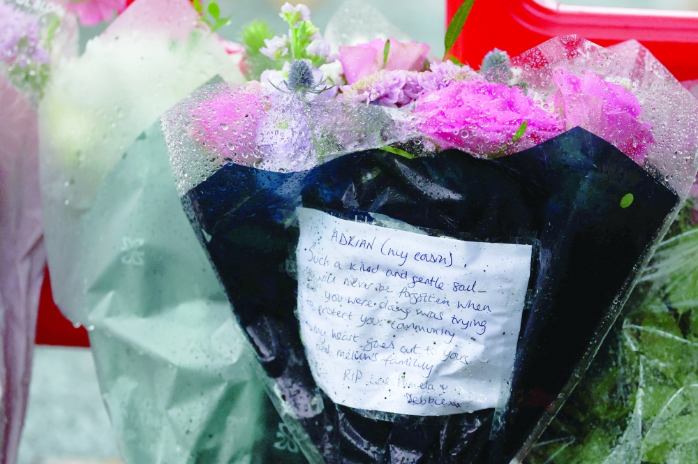 A note is left with flowers, near the Manchester synagogue, in what police have declared a terrorist incident, in north Manchester, Britain. — Reuters