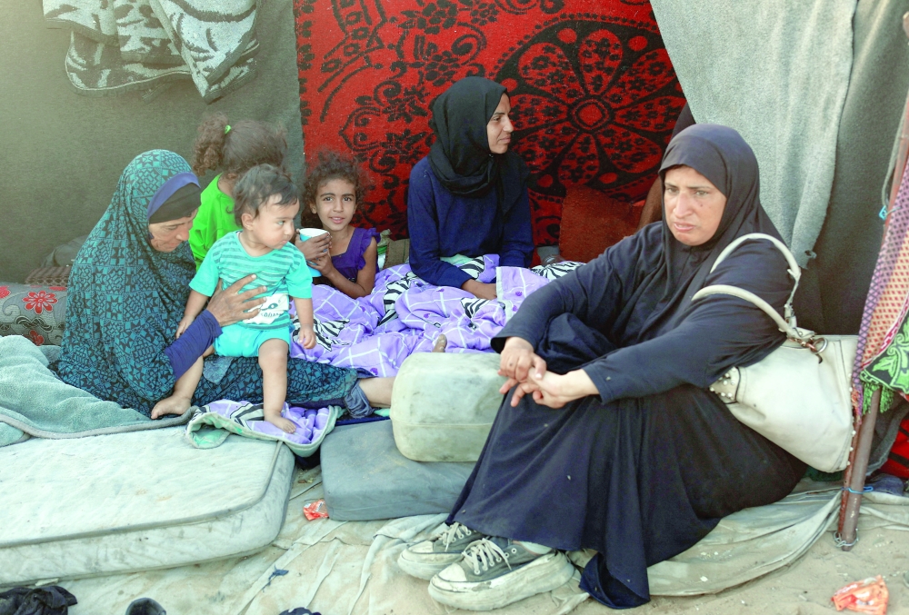 Displaced Palestinians from northern Gaza due to an Israeli military operation, rest after evacuating southwards in the central Gaza Strip. — Reuters