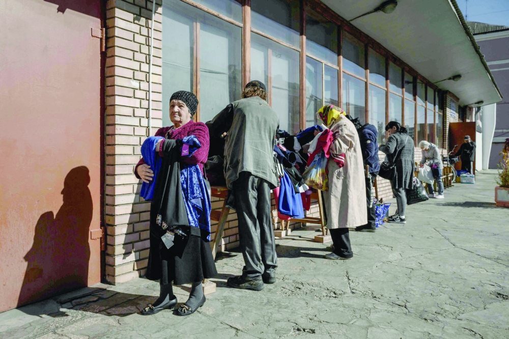 A woman holds some clothes at a distribution point in Kramatorsk, eastern Ukraine. — AFP