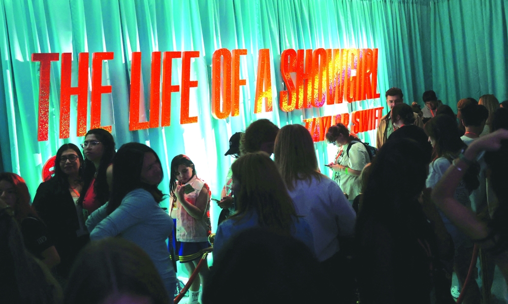 Swifties attend 'The Life of a Showgirl' pop-up in New York on October 2, 2025 to celebrate Taylor Swift's upcoming album "The Life of a Showgirl" at Spotify's three-day immersive experience. With the meticulously planned release of Taylor Swift's 12th album on October 3, the country singer-turned-pop star demonstrates again that she is as business savvy as she is musically adept. (Photo by TIMOTHY A. CLARY / AFP)