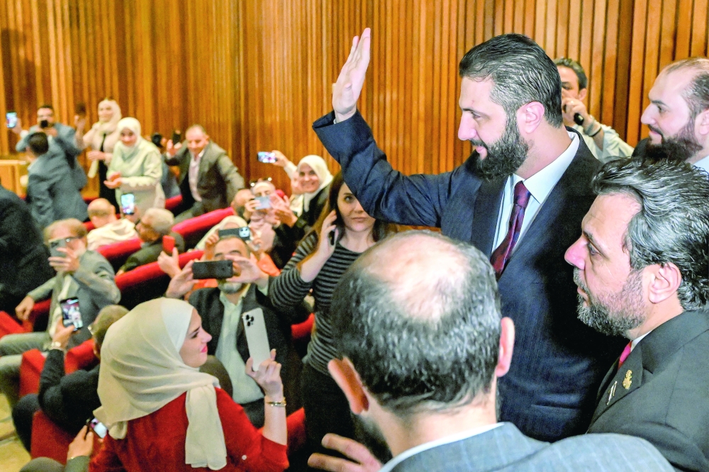 Syria's interim President Ahmed al Sharaa visits a polling station, in Damascus. — AFP
