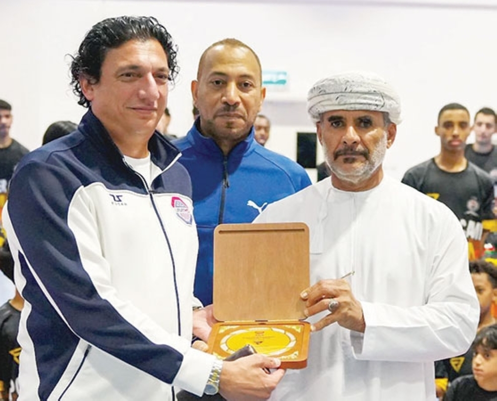 Ahmed al Obaidi, Harib al Abdali, and Brig Abdulmalik al Mazroue with the commemorative award at Power Camp Oman.