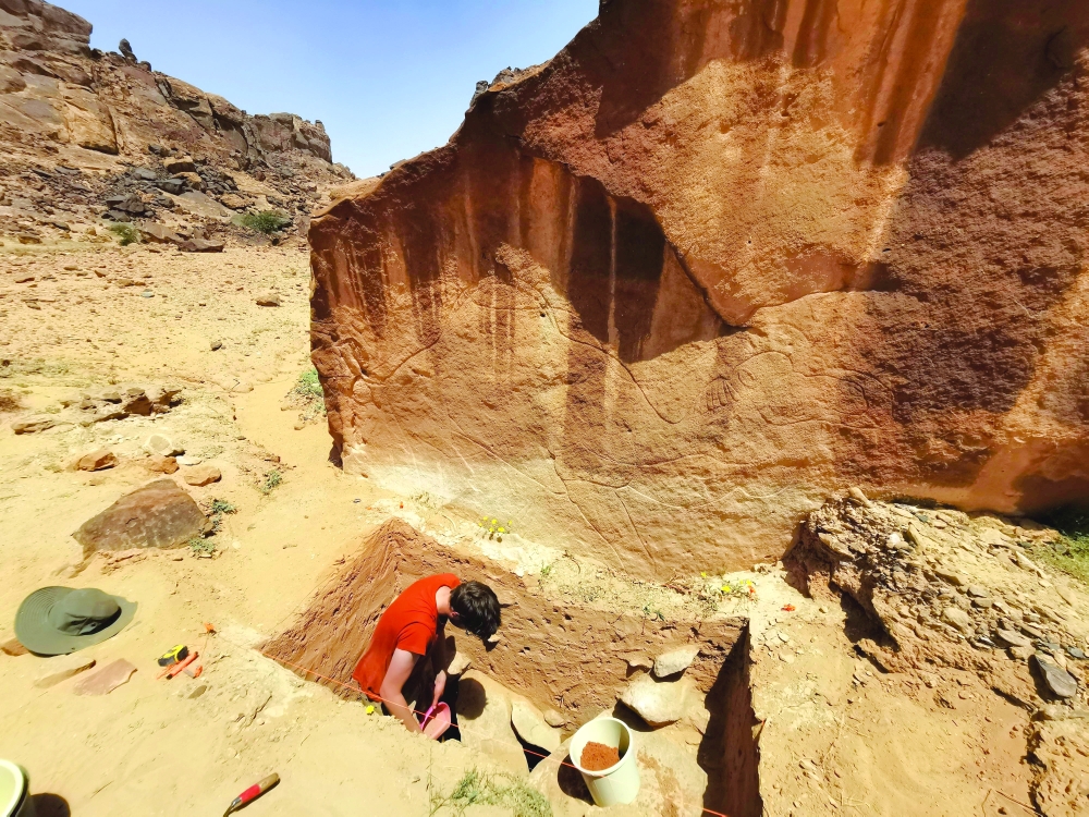 A view shows the excavation of a trench directly beneath a rock art panel bearing an engraving on sandstone of a camel at a location called Jebel Arnaan in an area south of the Nefud desert of northern Saudi Arabia, in this handout picture released on September 30, 2025.    Sahout Rock Art and Archaeology Project/Handout via REUTERS    THIS IMAGE HAS BEEN SUPPLIED BY A THIRD PARTY. NO RESALES. NO ARCHIVES.