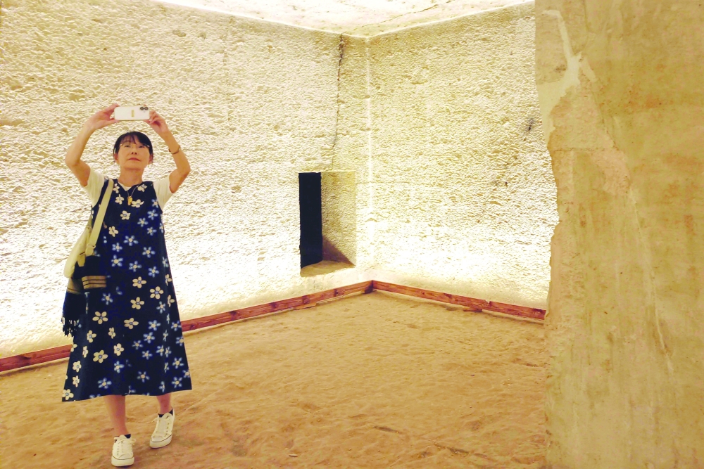 A tourist visits the tomb of King Amenhotep III in the Valley of the Kings near the city of Luxor on October 4, 2025, after it was officially opened to the public after nearly two decades of restoration and maintenance work supported by UNESCO and the Japanese government.  (Photo by AFP)
