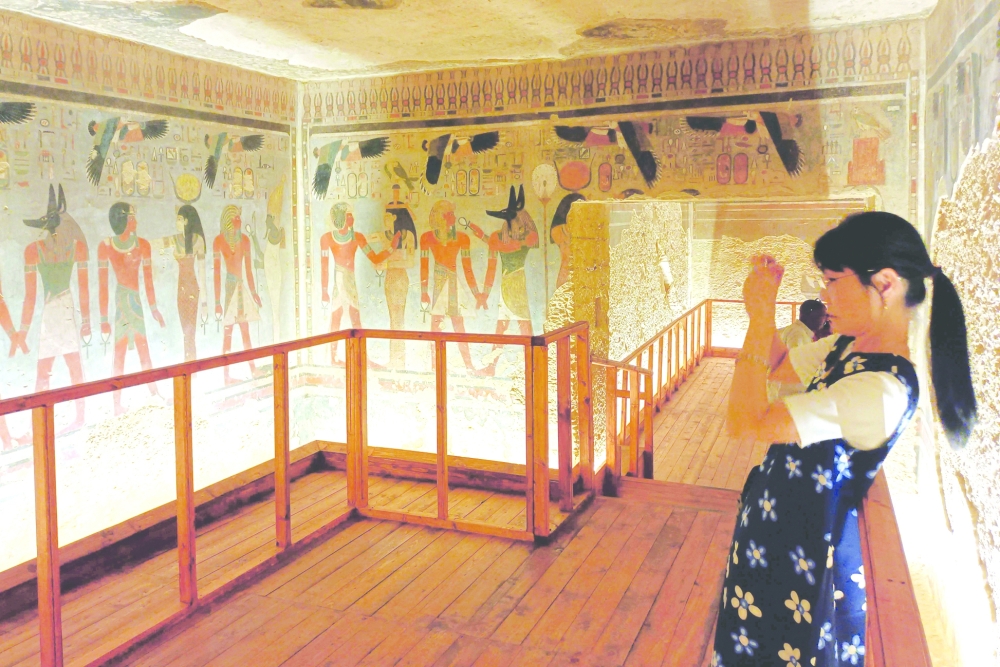 A tourist visits the tomb of King Amenhotep III in the Valley of the Kings near the city of Luxor on October 4, 2025, after it was officially opened to the public after nearly two decades of restoration and maintenance work supported by UNESCO and the Japanese government.  (Photo by AFP)
