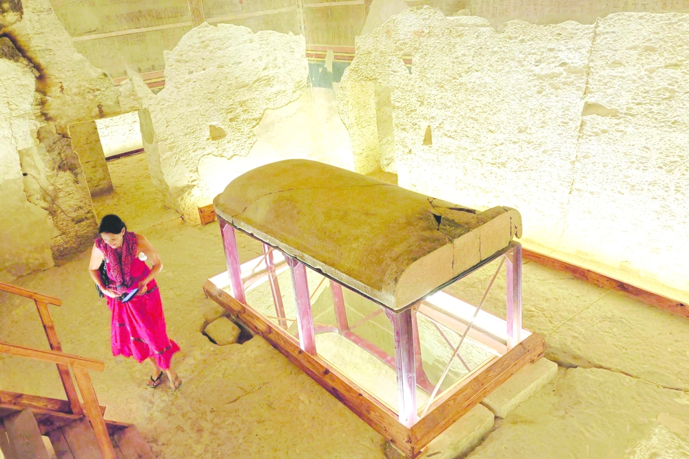 A tourist visits the tomb of King Amenhotep III in the Valley of the Kings near the city of Luxor on October 4, 2025, after it was officially opened to the public after nearly two decades of restoration and maintenance work supported by UNESCO and the Japanese government.  (Photo by AFP)
