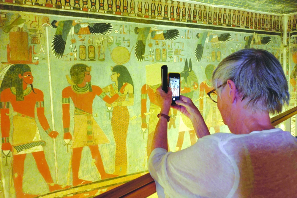 A tourist visits the tomb of King Amenhotep III in the Valley of the Kings near the city of Luxor on October 4, 2025, after it was officially opened to the public after nearly two decades of restoration and maintenance work supported by UNESCO and the Japanese government.  (Photo by AFP)
