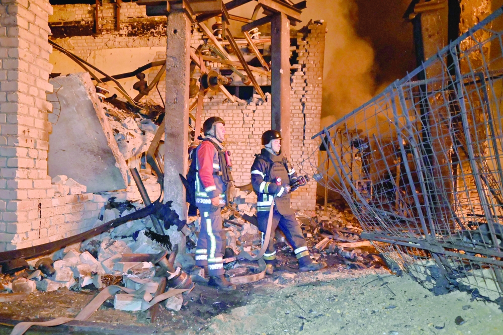 Ukrainian rescuers work among the rubble at an energy infrastructure facility, in Kharkiv. — AFP