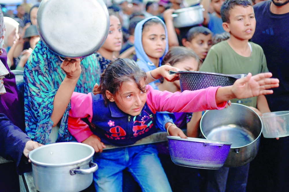Palestinians gather to receive food