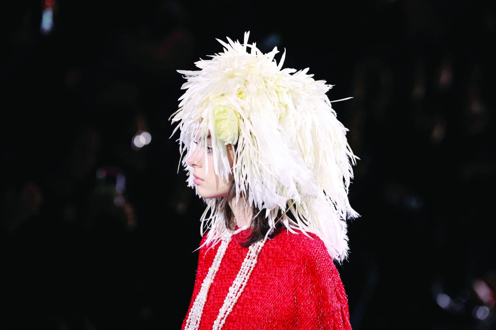A model presents a feathers hat by Chanel for the Women Ready-to-wear Spring-Summer 2026 collection as part of the Paris Fashion Week, at the Grand Palais in Paris on October 6, 2025. (Photo by Anne-Christine POUJOULAT / AFP)
